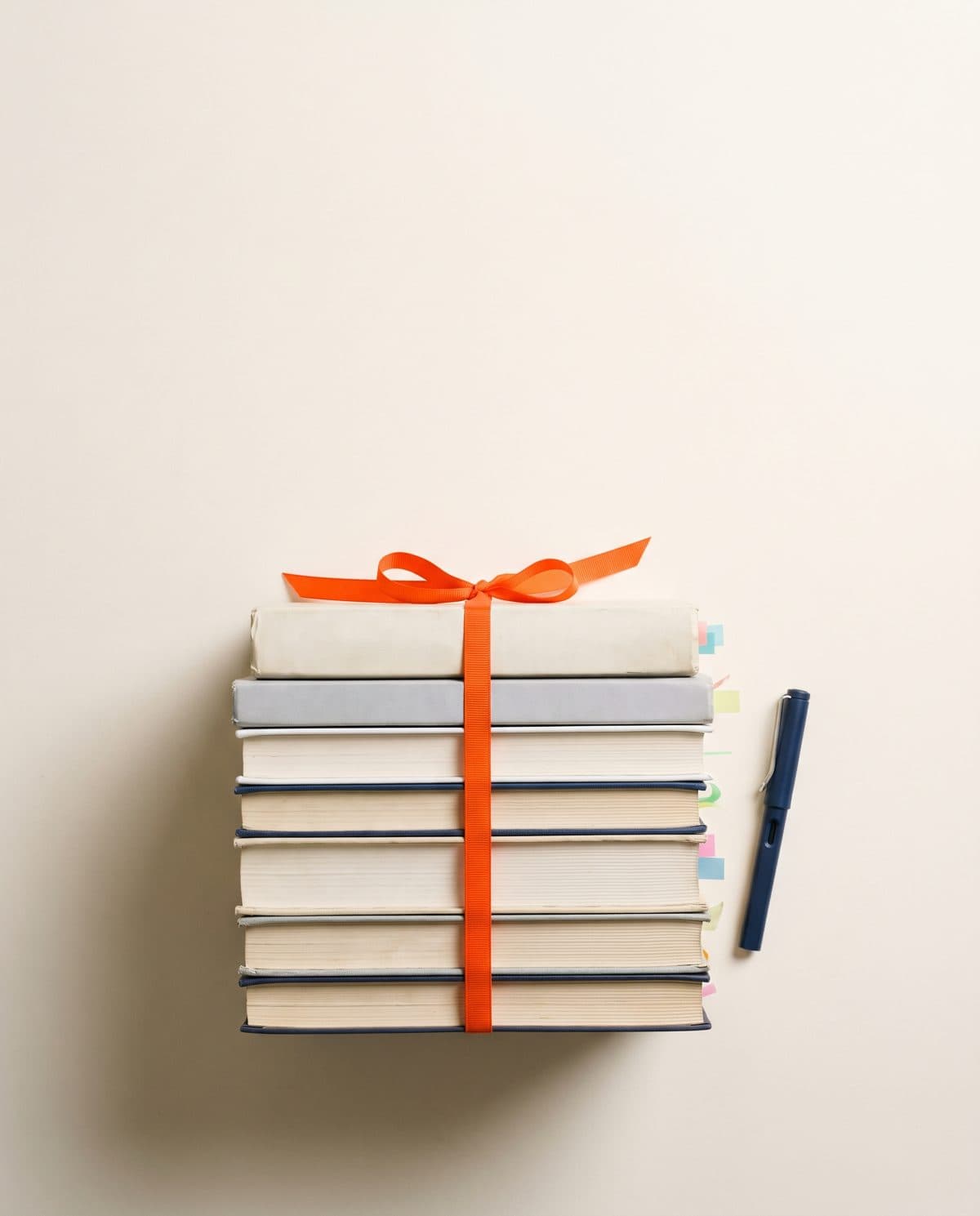 A stack of English textbooks tied with an orange ribbon